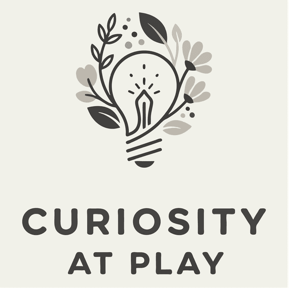 Stylized lightbulb with a pen nib and floral elements above text 'CURIOSITY AT PLAY'.