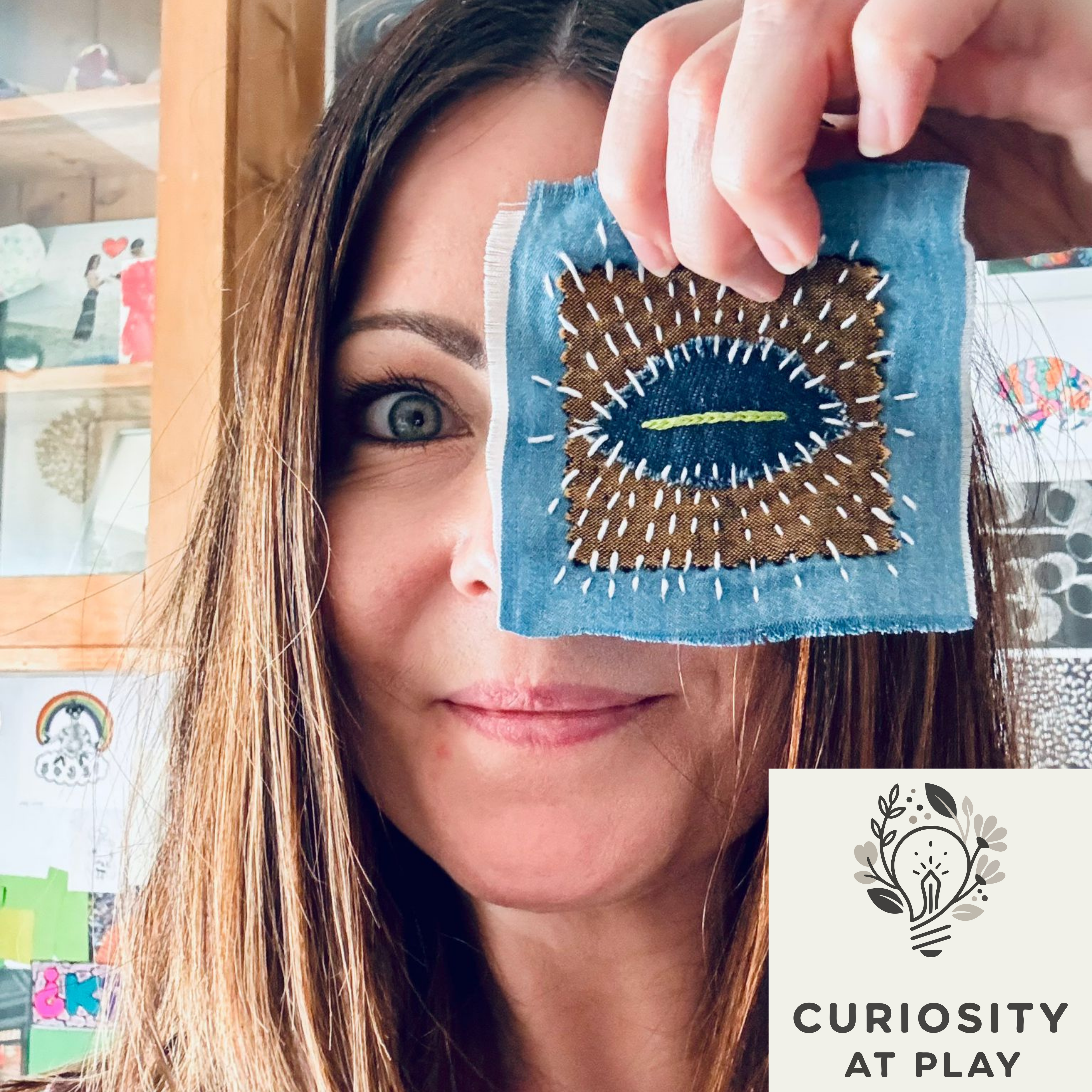 Woman holding a hand-stitched fabric eye over her eye, with Curiosity at Play logo.